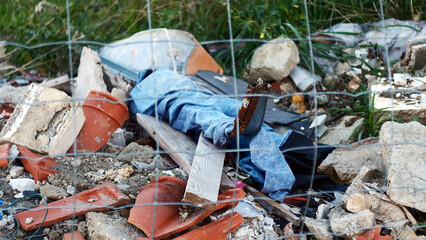Waste from construction work close-up, illegal dumping of garbage in nature, environmental pollution, environmental disaster France, Europe