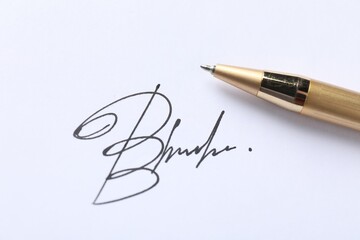 Pen and signature on white paper, closeup