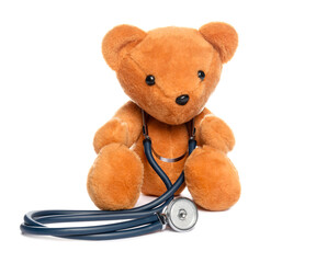 Pediatrics concept. Teddy bear and stethoscope isolated on white