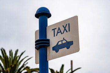 A blue pole with a sign that says 