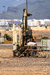 A man is working on a machine in a field