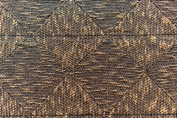 Fototapeta premium A brown and black patterned rug with a diamond shape design