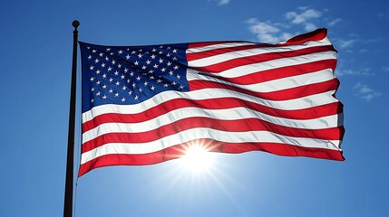 Obraz premium America flag flying on a flagpole silhouetted by the setting sun