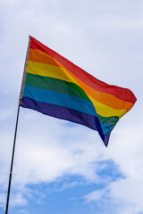 LGBTQ flag Low angle view of rainbow against a blue sky on a sunny day