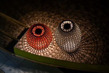 Two vases with a light shining on them