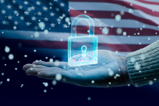 Hand holding a glowing digital padlock symbolizing data protection and cybersecurity with the american flag in the background. concept of the possibility of a National Data Protection Law in the