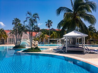 Swimming pool with water and palm tree in holiday resort in Caribbean, Cuba
