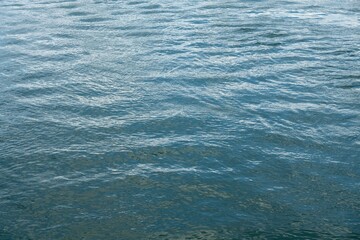 Blue abstract water surface with small waves and ripples
