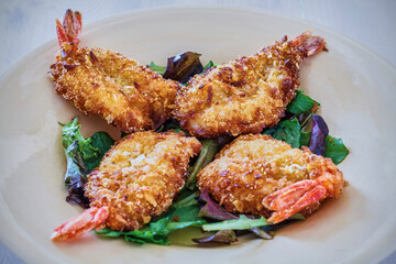 crispy fried coconut shrimp with a dipping sauce