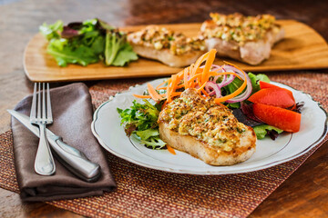 crusted broiled pork chops with a side salad