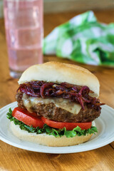 turkey burger topped with melted cheese and grilled red onions