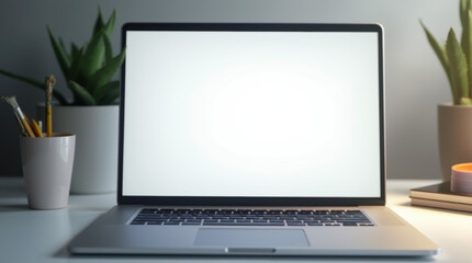Fototapeta premium A sleek modern laptop placed on a minimalist desk, with a bright, blank white screen