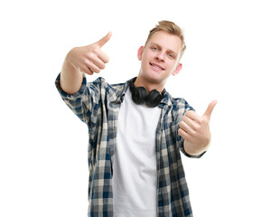 Happy man with headphones showing thumbs up on white background. Like gesture