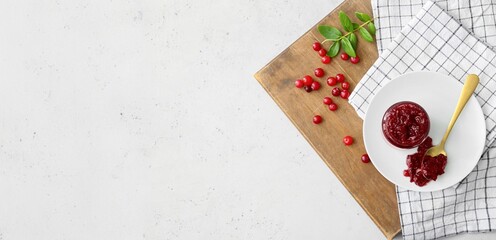 Composition with tasty cranberry jam on light background with space for text, top view