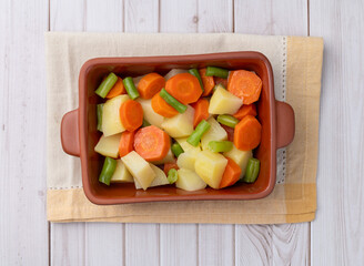 Cooked vegetables in a plate over wooden table