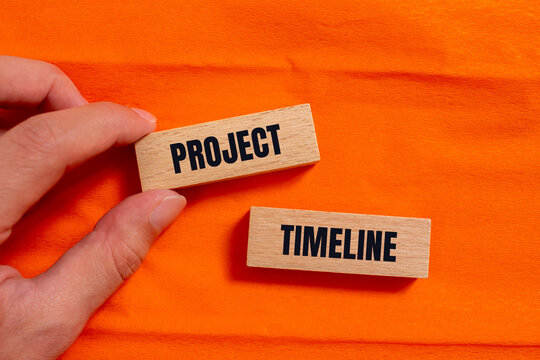 Project timeline message written on wooden blocks with orange background. Conceptual project timeline symbol. Copy space.