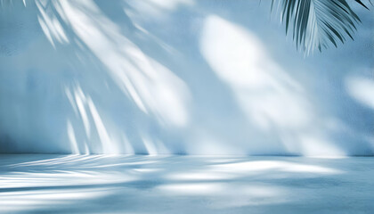 Serene Tropical Studio Background: Light and Shadow Play on a Blue Wall with Palm Fronds