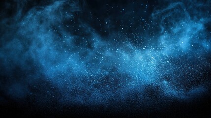 Obraz premium Abstract blue dust and smoke particles on black background.