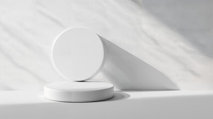 Minimalist display of two circular white objects atop a marble surface filled with soft natural...