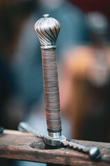 A sword with a silver handle and a gold tip