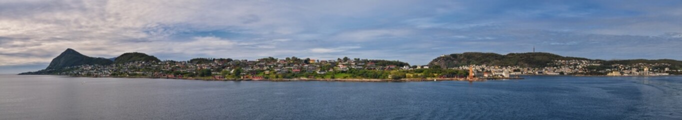 Fototapeta premium Norway Coast Fjord view from boat on ocean. Mountains, forests, waterfalls and small towns. Scandinavia, Norway