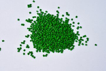Green masterbatch granules on white background,color pigment carrier polymer in plastic...