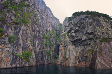 Fototapeta premium Norway Coast Fjord view from boat on ocean. Mountains, forests, waterfalls and small towns. Scandinavia, Norway