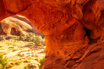 USA, Arizona, Monument Valley Navajo Tribal Park. Honeymoon Arch shelter in rock overhang.