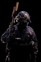 Special forces soldier equipped with advanced gear and weaponry in dark environment