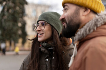 Happy couple wearing winter clothes enjoying a day out together