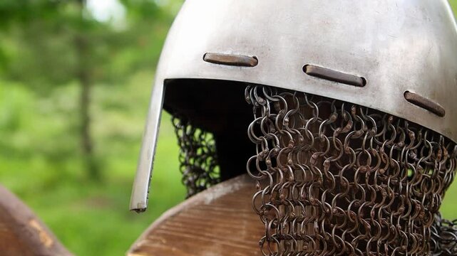 Close-up of a medieval Viking helmet, smooth camera movement, selective focus.
