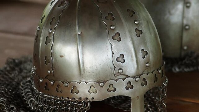 Close-up of a medieval Viking helmet, smooth camera movement, selective focus.

