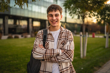 Portrait of young adult arm crossed man outdoor on sunny day