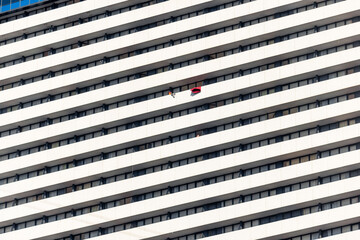 A red blanket disrupts the rhythm of the balconies