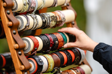 A person is reaching for a bracelet on a display