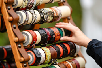 A person is reaching for a bracelet on a display