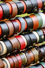 A row of leather bracelets are displayed in a store