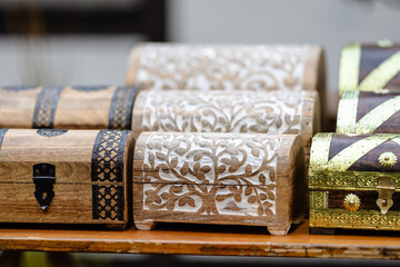 A row of wooden boxes with white designs on them