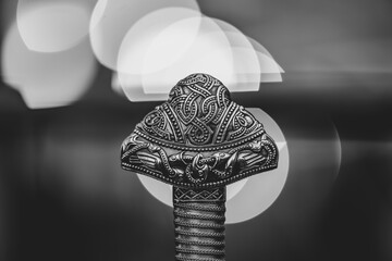 A silver object with a design on it