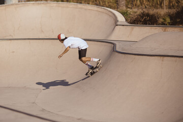 Cool skateboarder outdoors - young guy jumping with his skate and performing a trick © Buyanskyy Production
