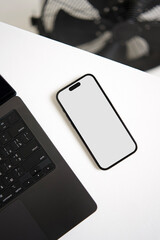 Smartphone mockup on a white office desk