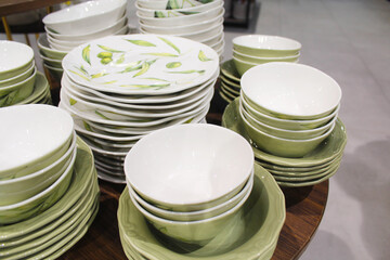 stack of plates, a lot of different plates on a table