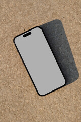 Realistic smartphone mockup on a brown concrete surface