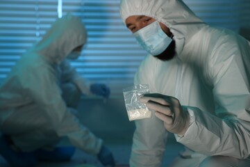 Forensic experts working at crime scene indoors, selective focus