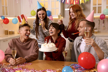18th birthday. Group of friends with tasty cake having coming of age party at home