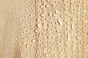 Water drops on wooden surface, close-up