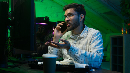 Stressed Arabian Indian man male guy looking code coder programmer technology talk mobile phone...