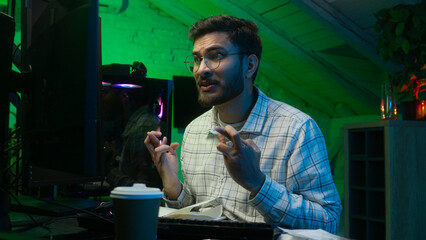 Worried Indian Arabian man guy streamer programmer hacker computer hope cross fingers loss failure...