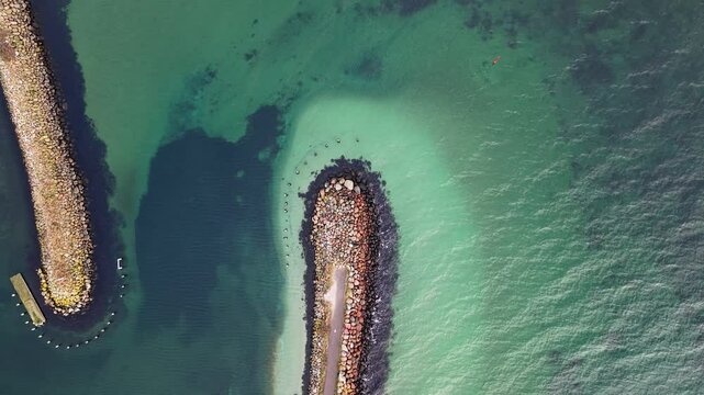 Aerial descent of end of breakwater out to Kattegt sea, Egaa Harbor, Denmark