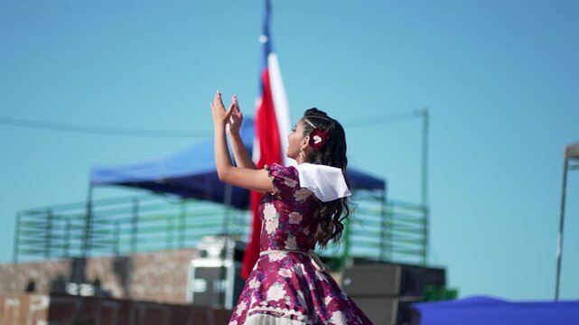 Energetic chilean dancers showcase traditional cueca dance steps on an outdoor stage